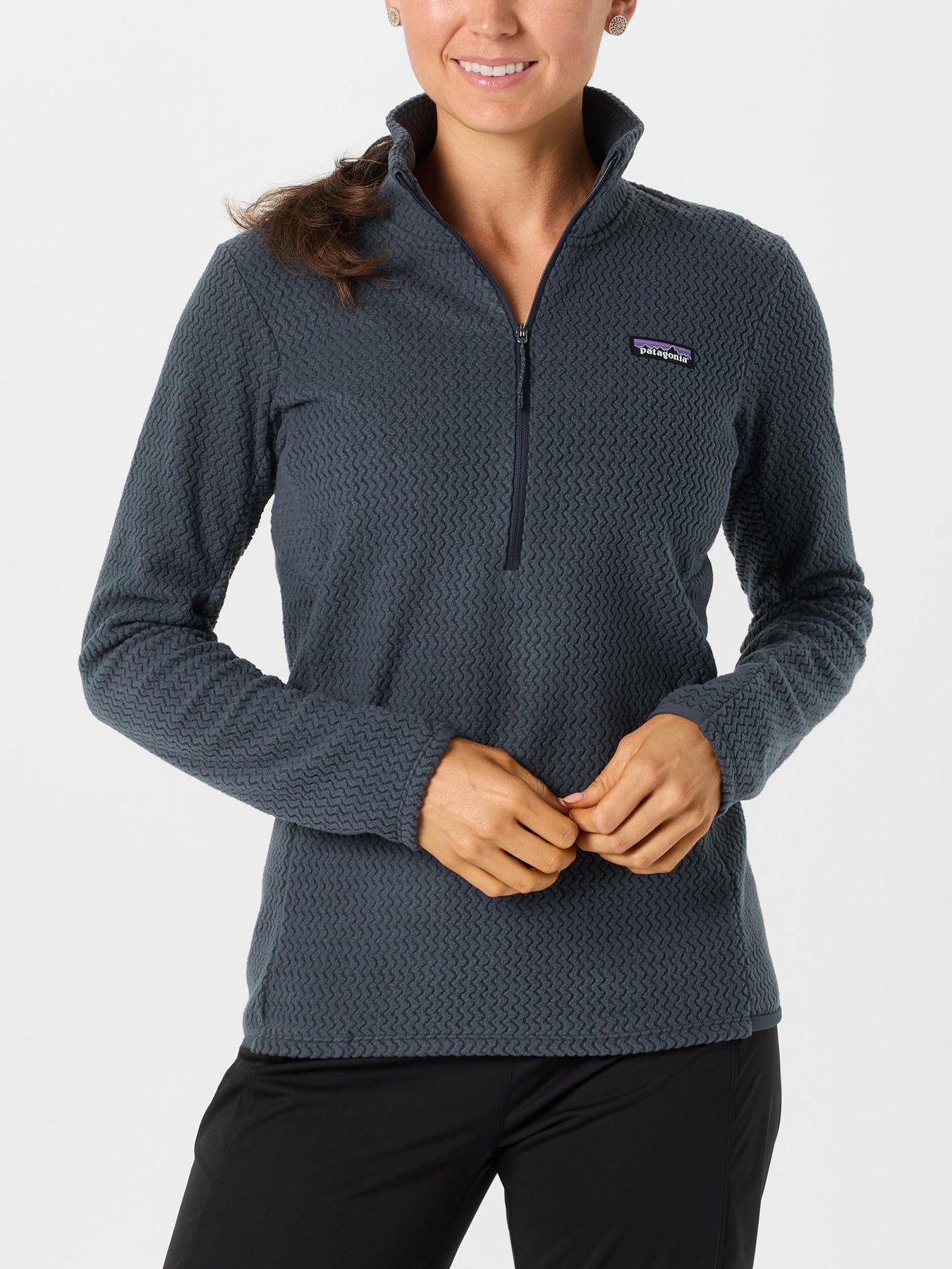 Female model wearing the Patagonia R1 Air Zip Neck in a smolder blue colorway