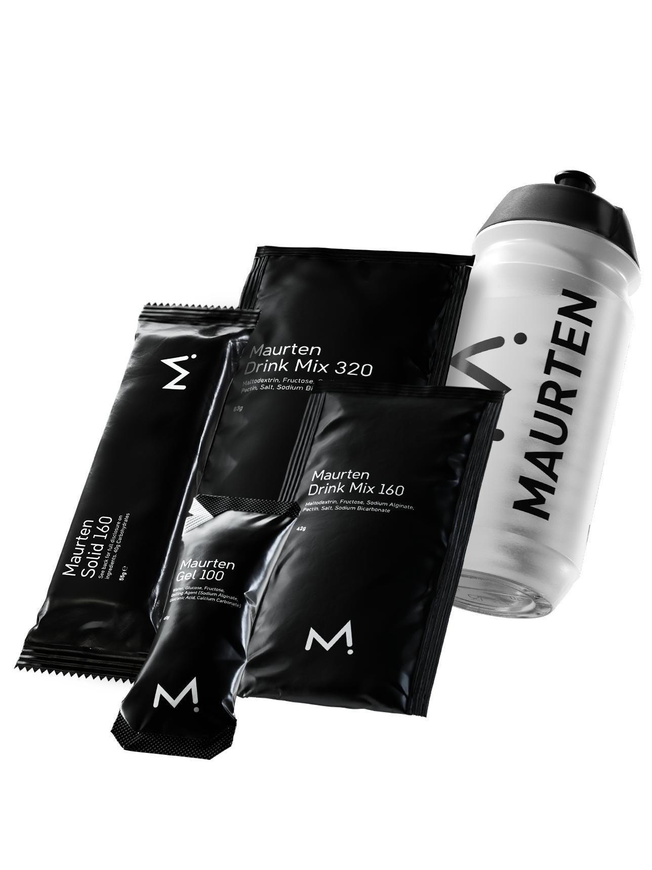 Black and white Maurten sports nutrition products, including drink mixes, a gel, and a bar, are displayed beside a branded water bottle.