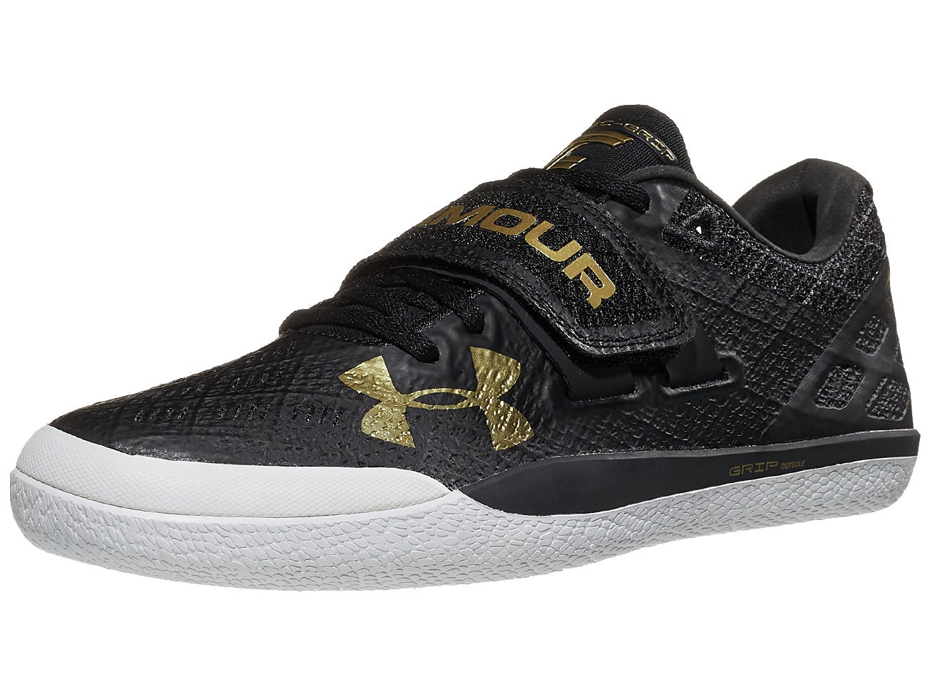 Angled view of Under Armour Centric Grip glide shoe in black and white color with gold accents