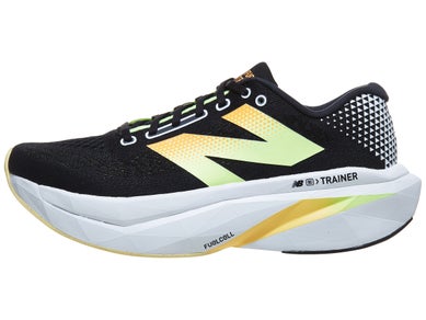 Side view of New Balance SuperComp Trainer shoe in black color with neon green and orange accents, white midsole