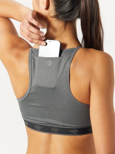 A model placing a phone in the back pockets of the rabbit Strappy bra