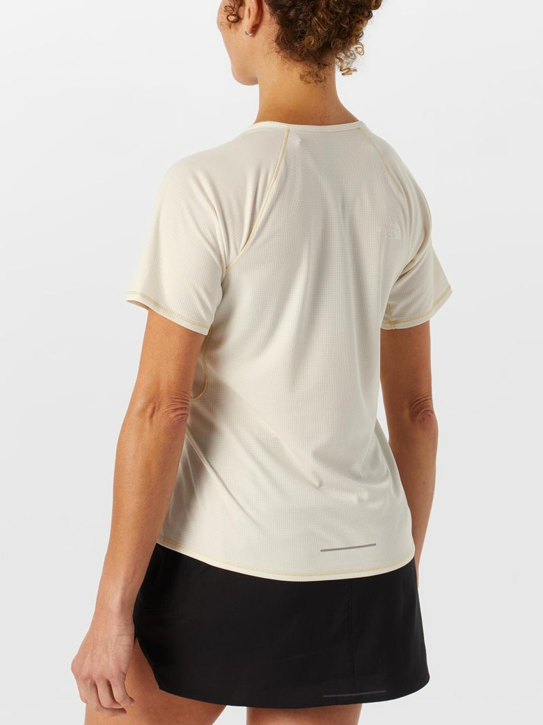 Back view of model wearing The North Face Women's Sunriser Short Sleeve in white dune color