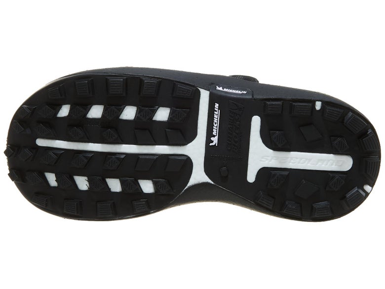 Close up bottom view of running shoe showing good detail of rubber and lugs