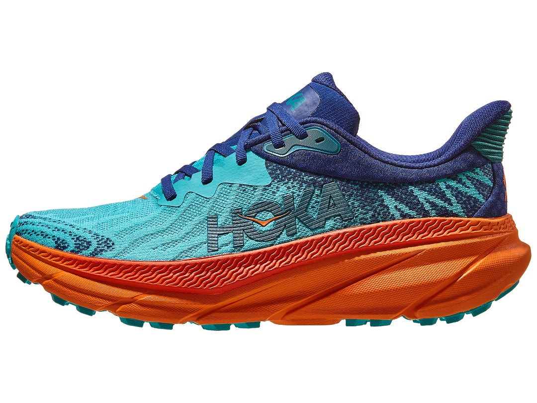 HOKA Challenger 7. Upper is a patterned blue and the midsole is orange color.