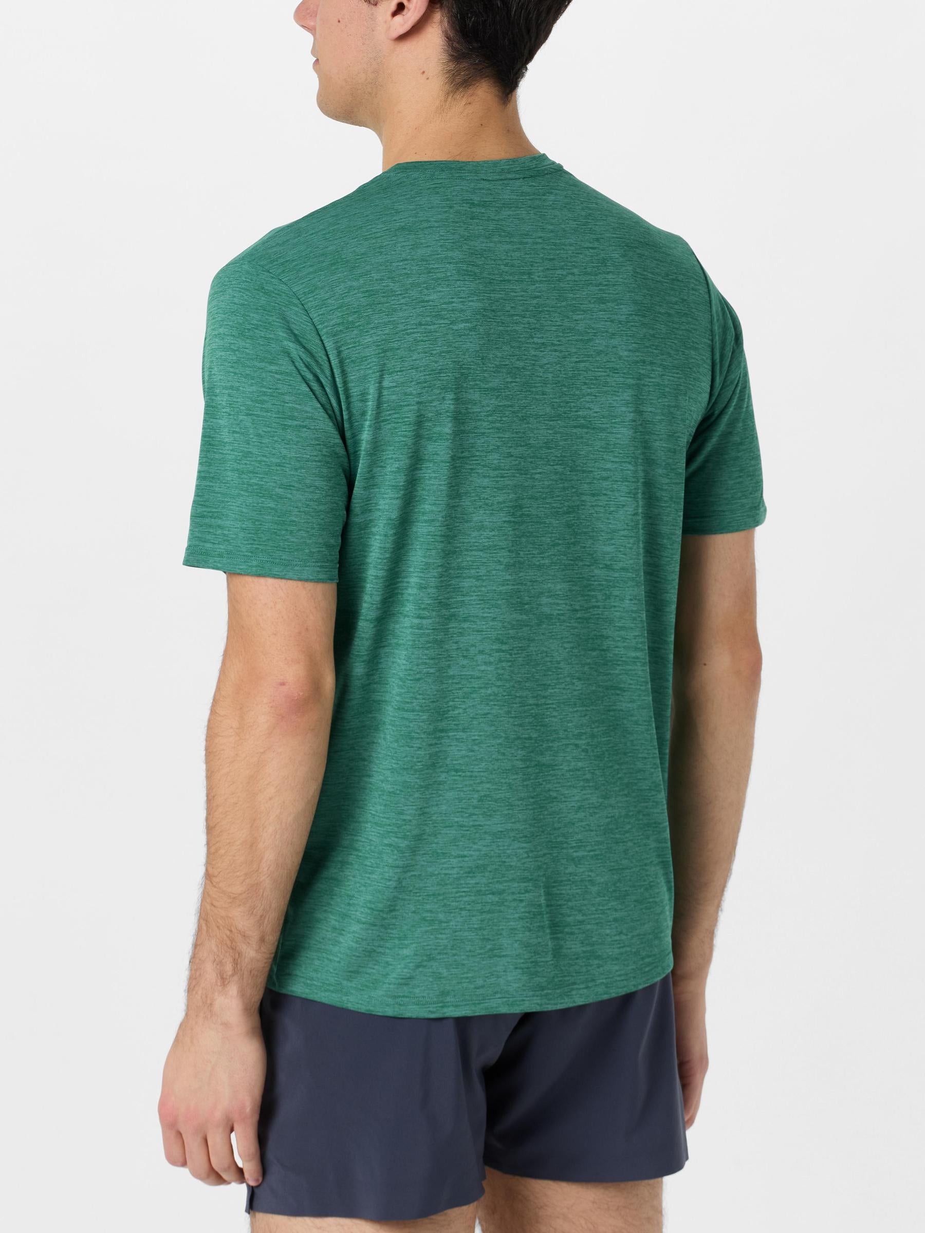 Back view of model wearing Patagonia Capilene Cool Daily Short Sleeve in green