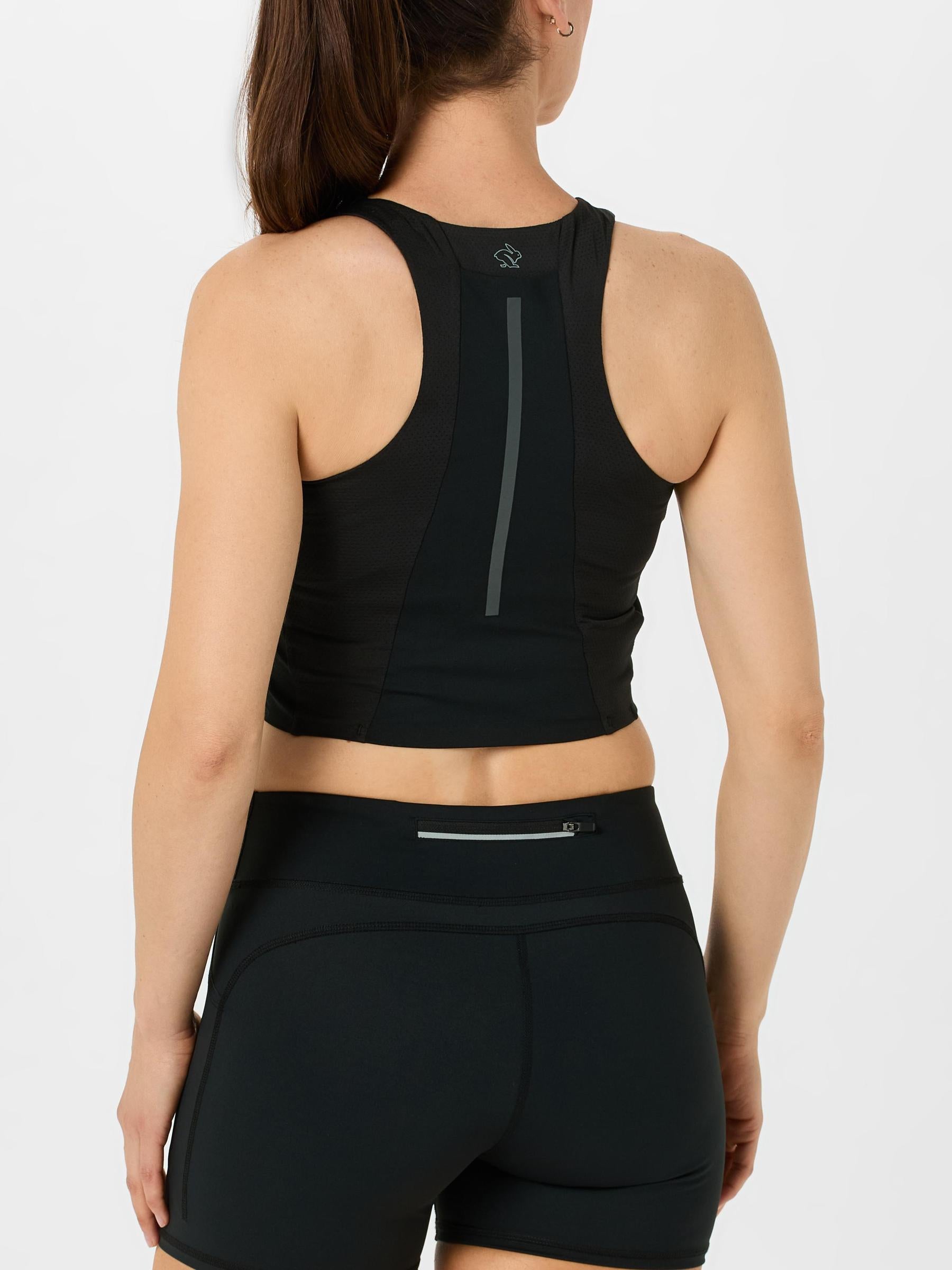 Back view of model wearing rabbit Women's Pacer Pocket Crop in black colorway
