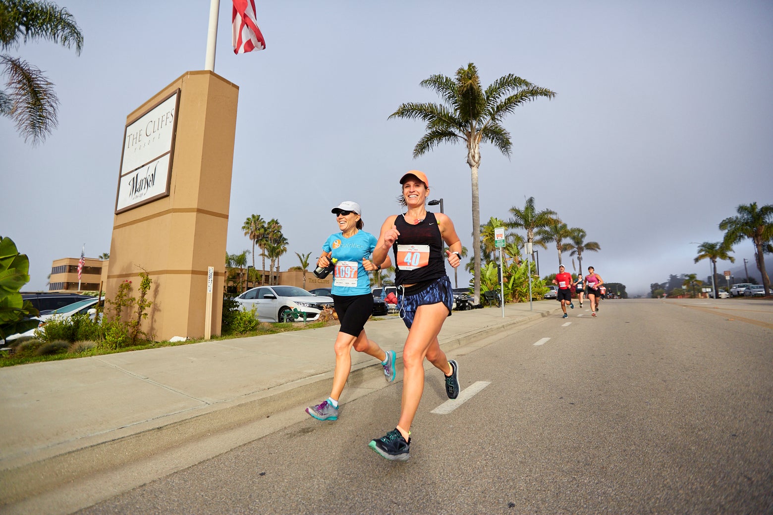 female runners wearing hats and participating in a race