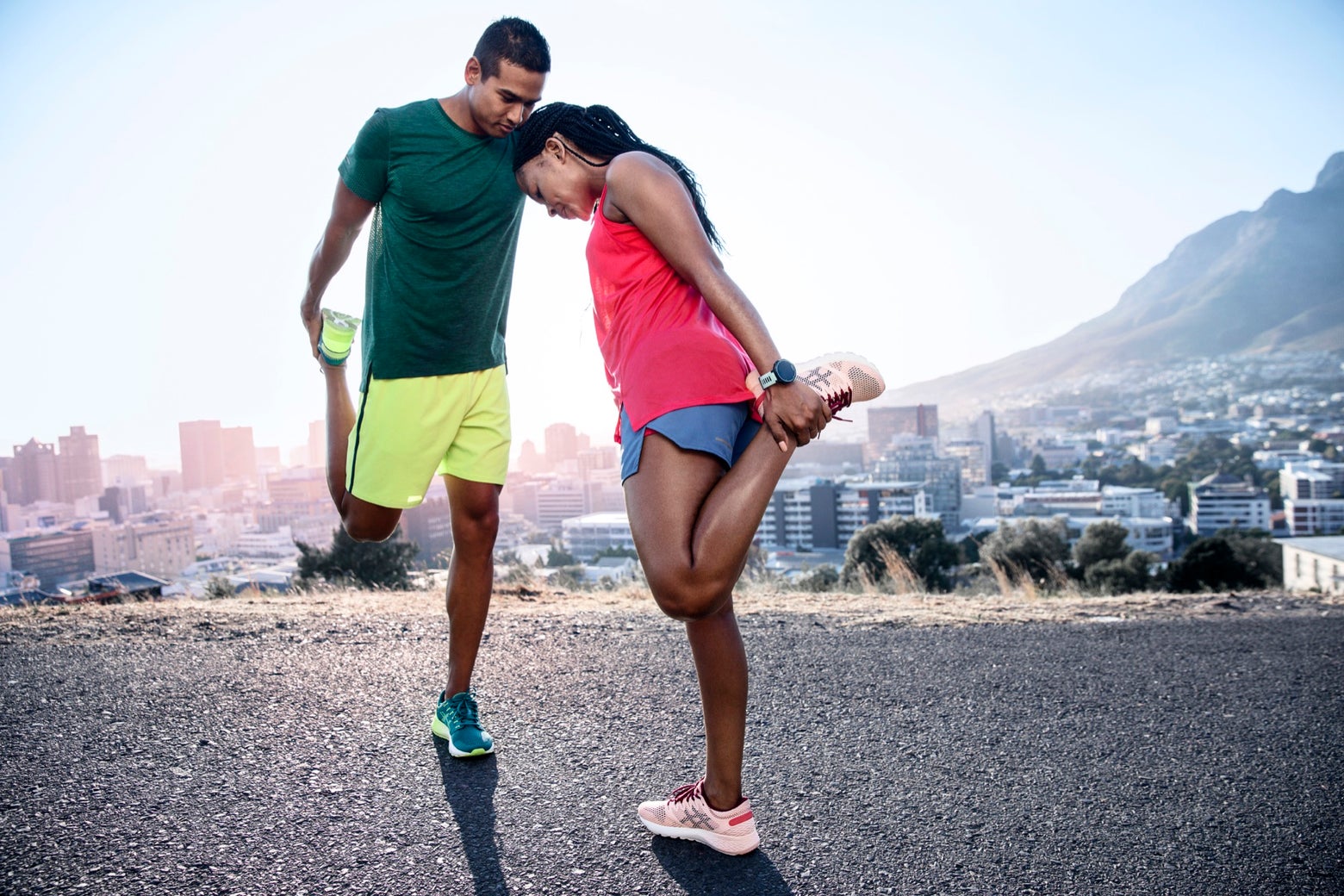 Man and women stretching their legs