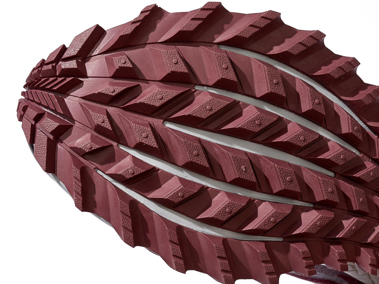 Close up bottom view of running shoe showing good detail of rubber and lugs