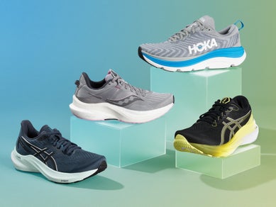 Four stability running shoes stacked on top of boxes