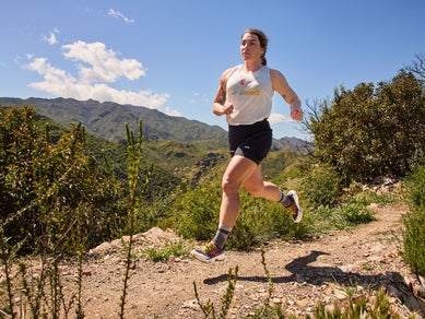 Woman trail running in Brooks Distance Tanks and shorts