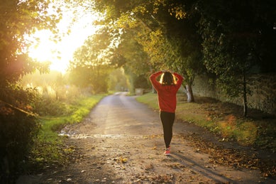 runner walking on bike path