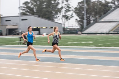 Two females running track