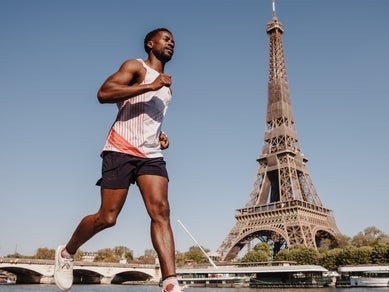 Man running by the Eiffel Tower in Paris, France