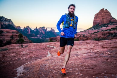 man running on red rocks