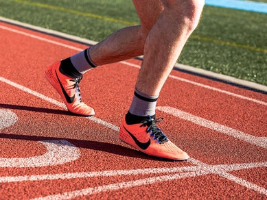 Close up of a runner's track shoes on a track field