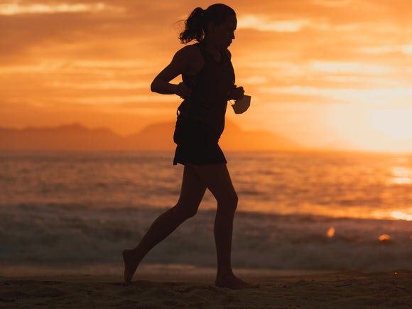 silhouette of runner on beach