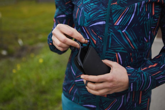 woman putting headphones in bag