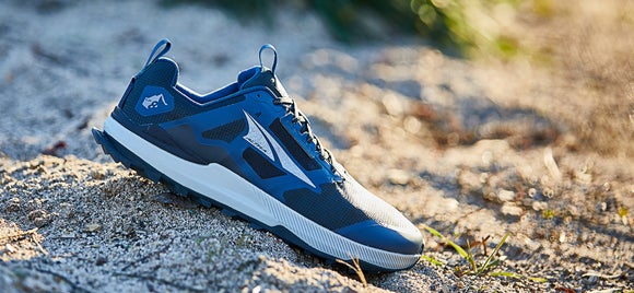 Close up shot of a Altra Lone Peak Shoe on an outdoor trail 