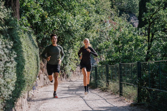 man and woman running outside