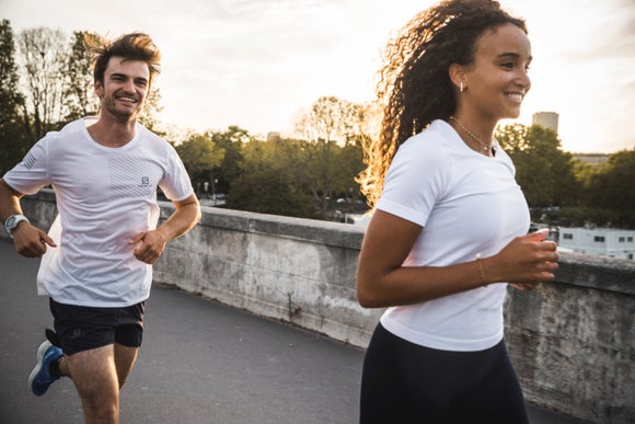 man and woman running on the road