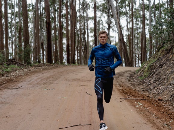 man running in compression tight