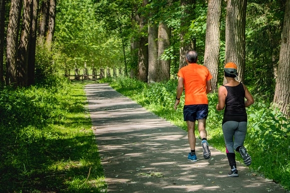 Runners on wooded bike path