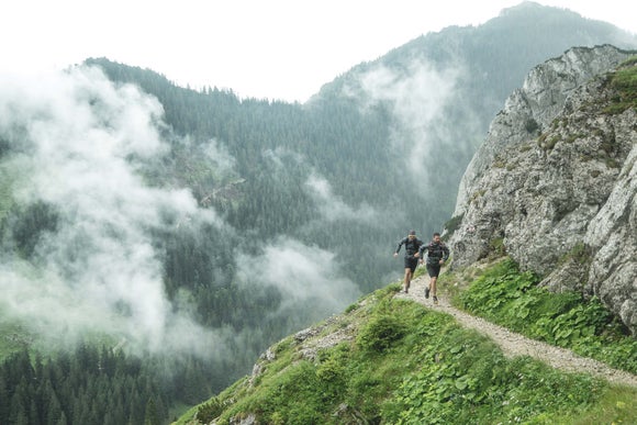 Two trail runners in rainy weather