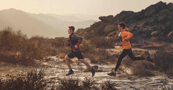 two men trail running in the rain