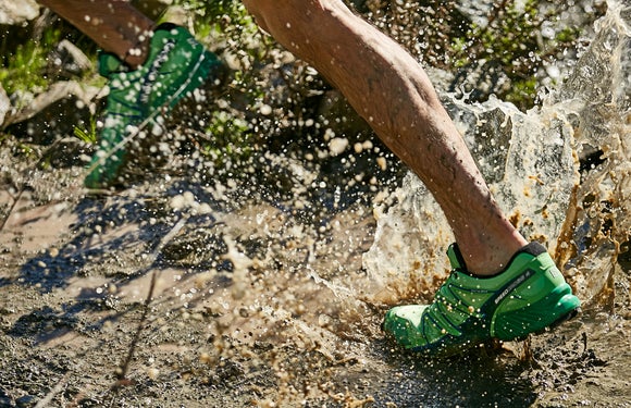 man running through puddle