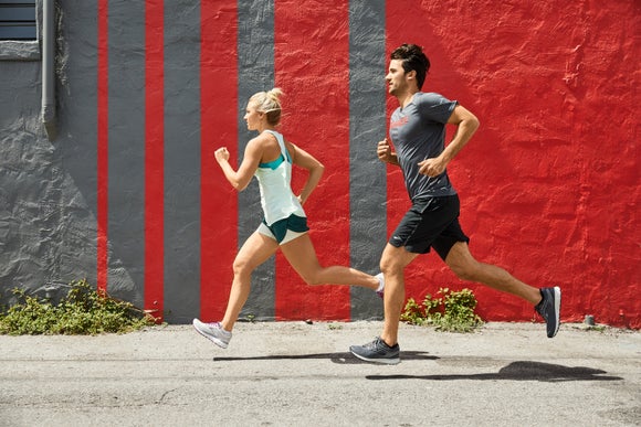 male and female runners on the road