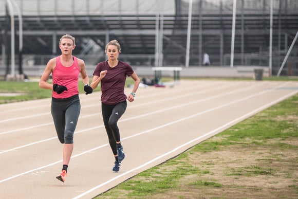 Two female runners on the track