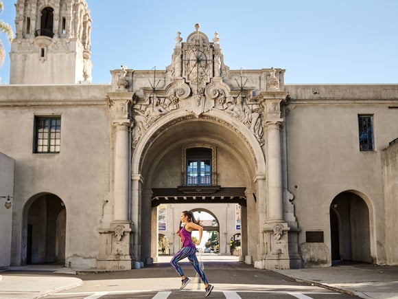 runner passing by an architectural landmark