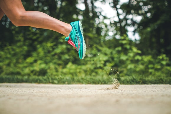 Woman running in cross country shoes