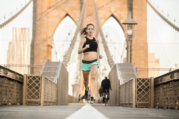 Woman running on a bridge