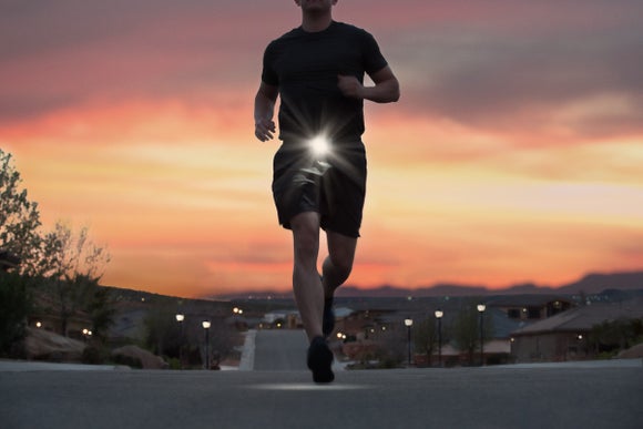 runner wearing belt light at dawn