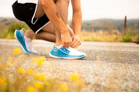 A runner tying his shoes