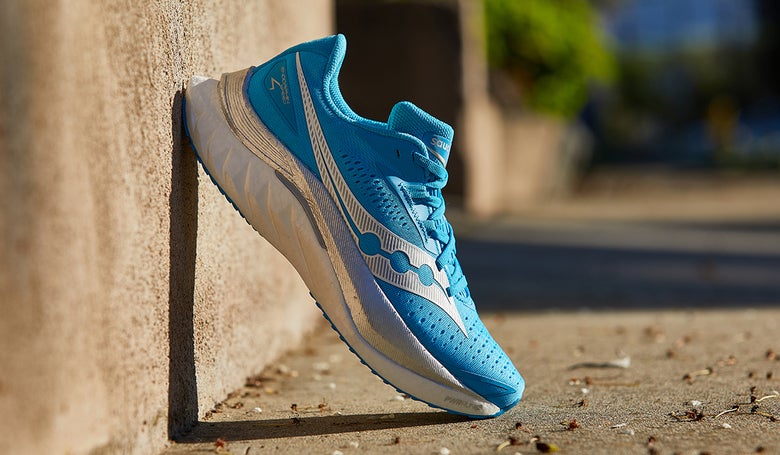 Saucony Endorphin Speed 4 shoe propped up against a wall outside