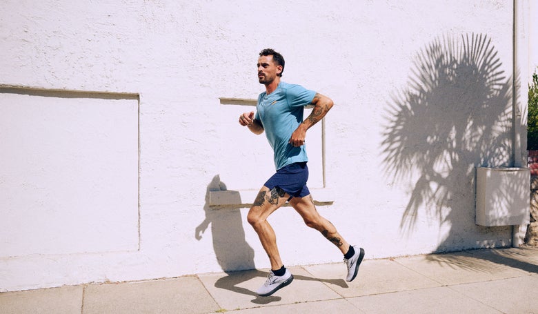 male runner irunning on water road in city marathon race, shoes