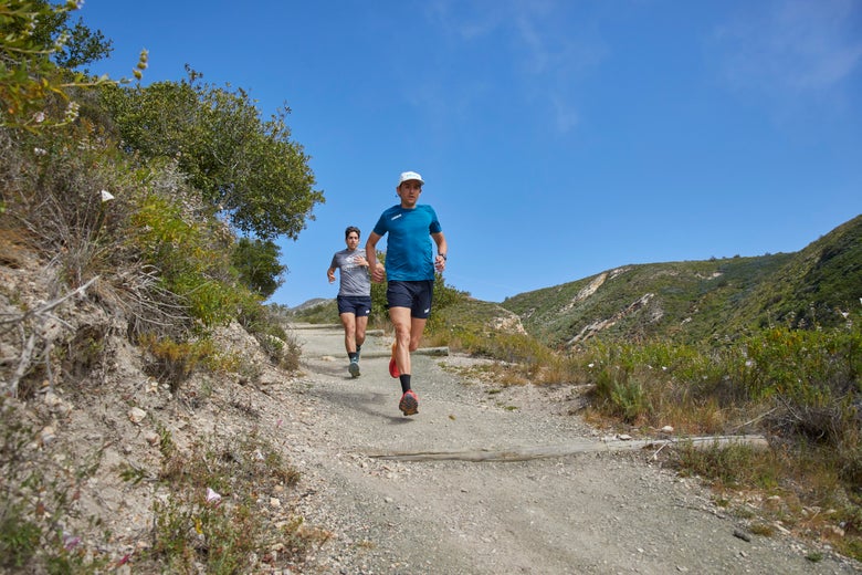 Hoka trail running shoes on gravel path during ultra-distance training
