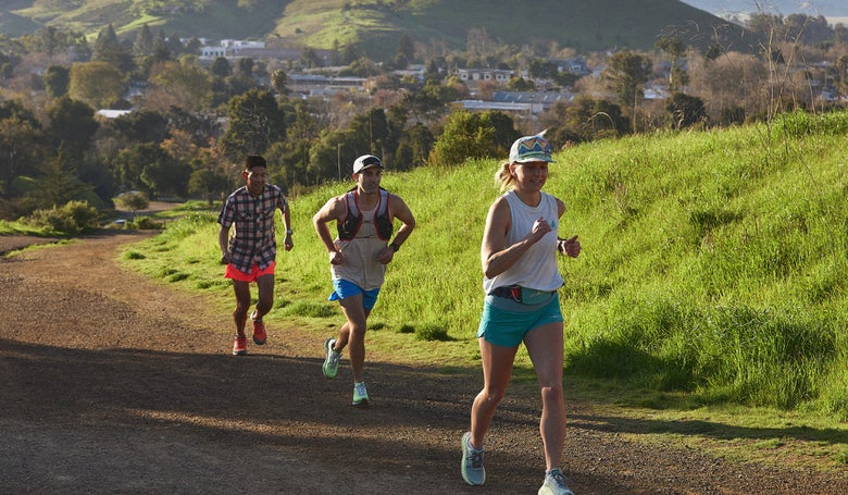 Running Warehouse employees running on a trail in SLO