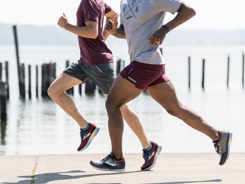Two people running on a beach