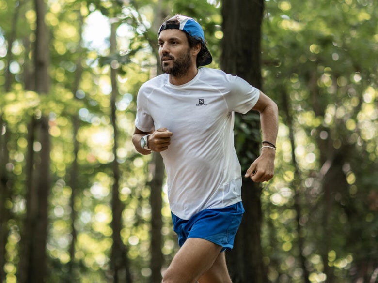 Person running on a trail in the woods