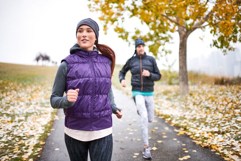 two female runners wearing running vests