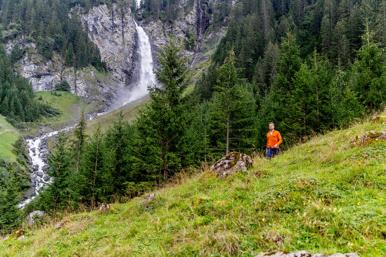 Hiker in the mountains overlooking a waterfall