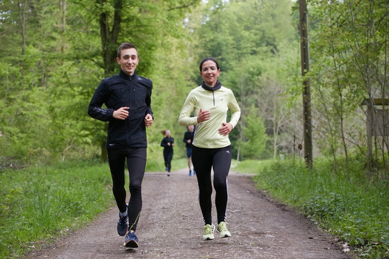 Man and woman trail running