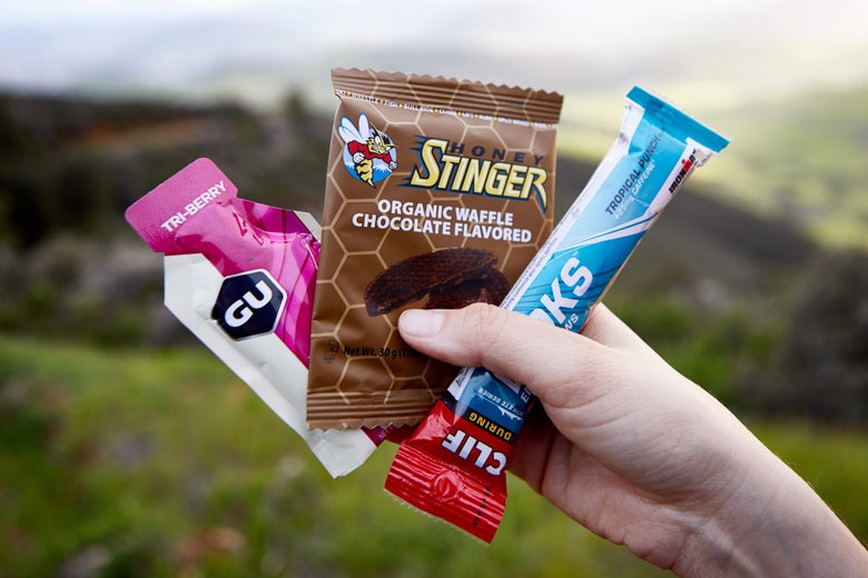 Hand holding multiple running nutrition products