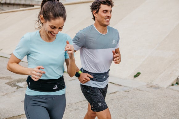 male and female runners wearing a running belt