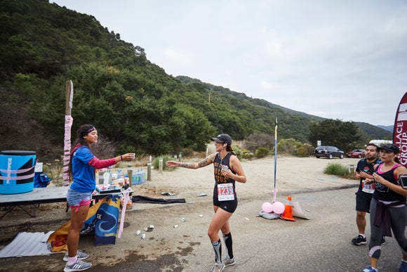Runner getting water from an aid station
