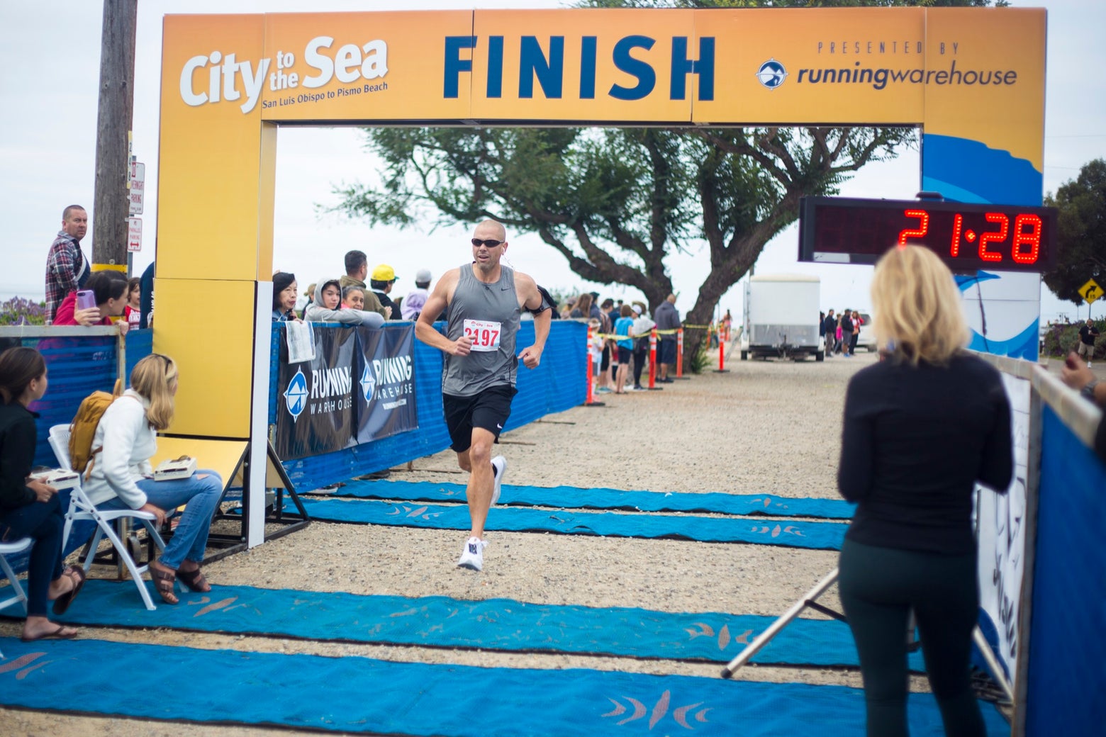 Male runner crossing the finish line